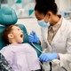 pediatric dentist making child laugh in dental chiar