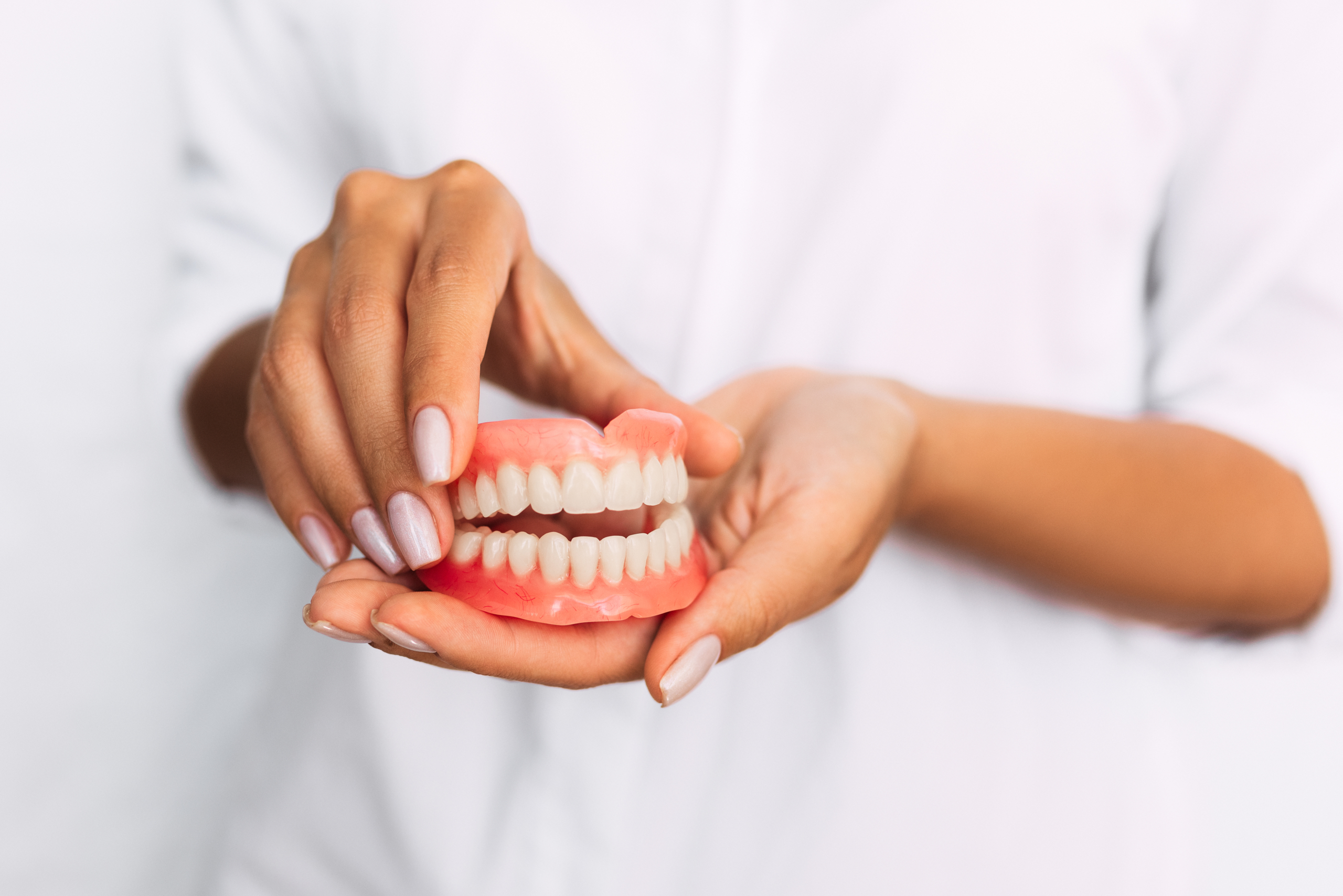 dentist holding denture mold