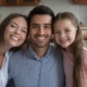 family smiling after visiting dentist with white teeth