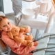 child sitting in chair at pediatric dentist