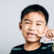 little boy showing knocked out front teeth in smile