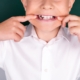 little boy showing off his smile with missing teeth