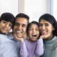 young family smiling all sitting next to eachother